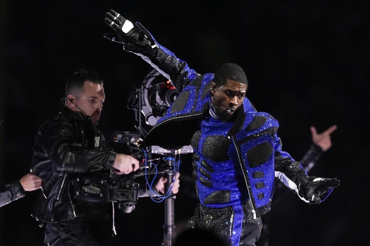 Usher+dances+in+a+black+and+blue+outfit+during+his+Super+Bowl+halftime+performance.+Usher+brought+out+several+musical+guests+during+his+show.+%28AP+Photo%2FGeorge+Walker+IV%29