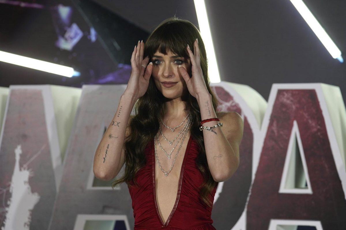 Dakota Johnson adjusts her hair on the premiere of Madame Web in Mexico. Madame Web has not been receiving great reviews from critics, but the film has redeeming qualities. (Marco Ugarte | AP Photo)
