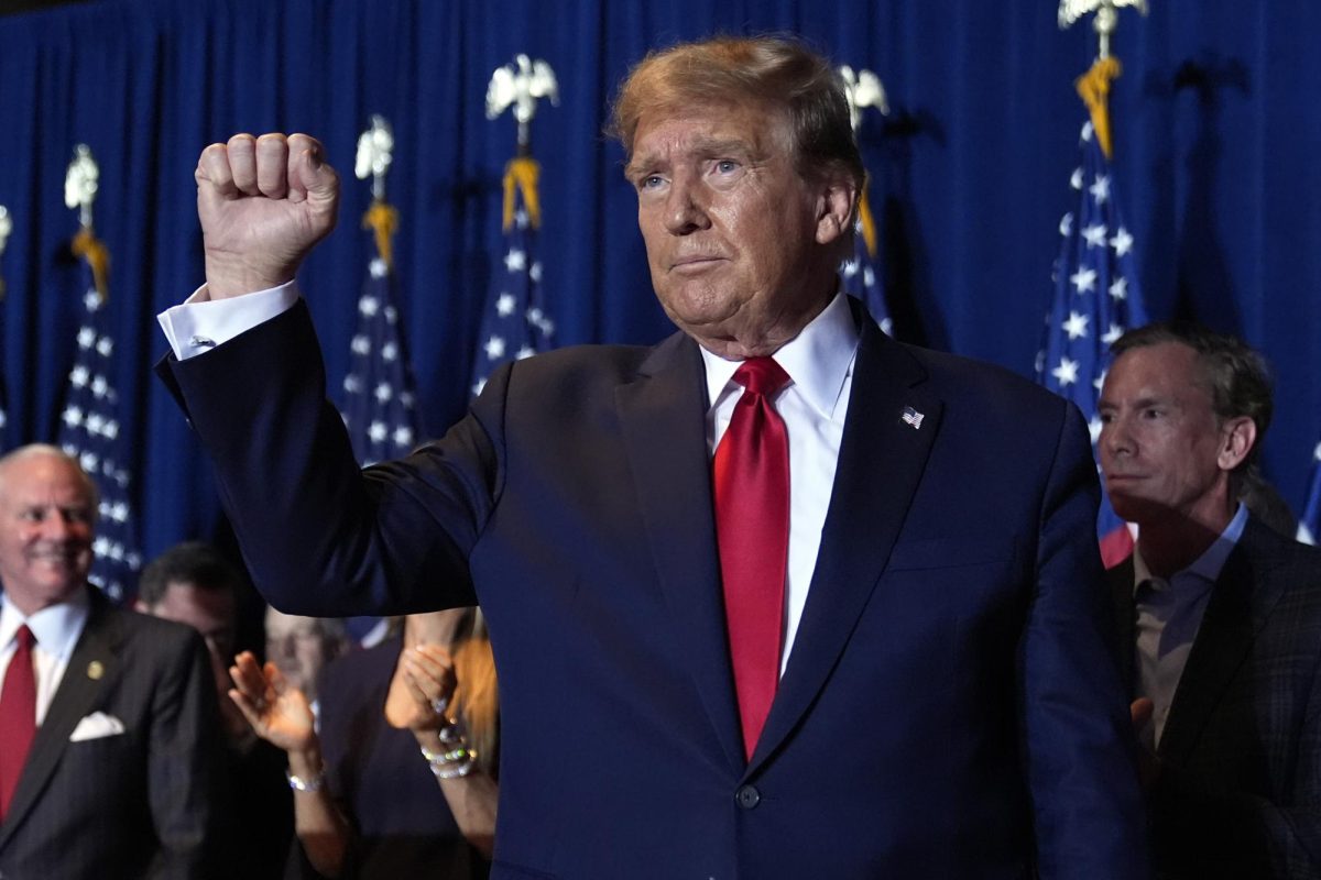 Former president Donald Trump raises a fist on Feb. 24 at a primary election night party in Columbia, South Carolina. Opinion Columnist Will Thiel believes Trump’s recent controversial statements about NATO were justified. (AP Photo | Andrew Harnik)
