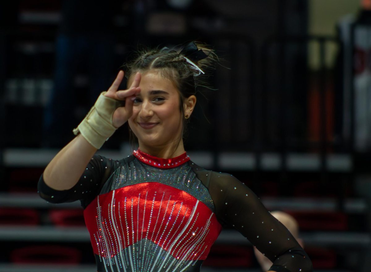 Junior gymnast Isabella Sissi poses during her floor exercise routine at NIU gymnastics and wrestlings Beauty and the Beast meet Friday. Sissi, an all-arounder, finished Fridays quad meet with a total score of 39.100. (Totus Tuus Keely | Northern Star)