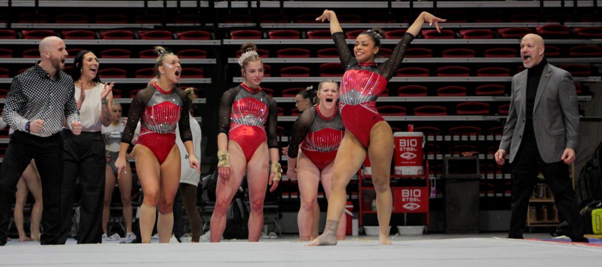 Freshman gymnast Isabella Ross poses while her teammates cheer for
her completed routine. NIU gymnastics will face Eastern Michigan University Sunday. (Totus Tuus Keely |
Northern Star)