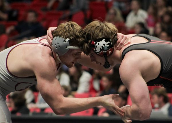 Freshman Sean Carroll (right) locks together with Lock Haven sophomore Cael Black. Carroll kept up with Black into overtime to win the match. (Totus Tuus Keely | Northern Star)