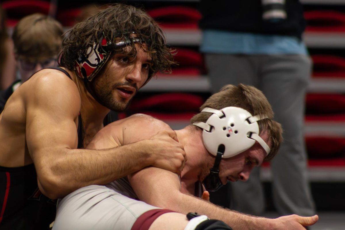 Redshirt Sophomore wrestler Ricardo Salinas (left) holds down Lock Haven junior wrestler Tyler Stoltzfus. Salinas was able to score four points, but lost by decision by seven points. (Totus Tuus Keely | Northern Star)