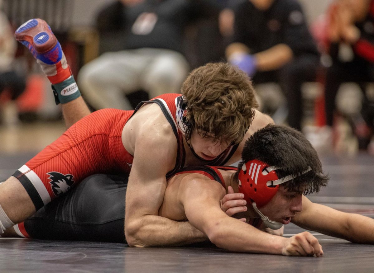 Redshirt sophomore Blake West attempts to pin Southern Illinois University Edwardsville redshirt sophomore Davian Guanajuato on Fridays Senior Day event for NIU wrestling. West defeated Guanajuato 4-3 on Friday to finish the season undefeated in dual matchups. (Tim Dodge | Northern Star)