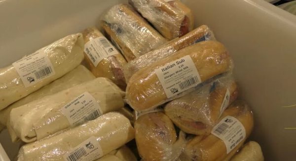 Stack of sandwiches prepared, wrapped and packed in a box wait to be shipped across campus. Dining services provides catering to all across campus including residential halls, restaurants and events. (Joseph Howerton | Northern Star)