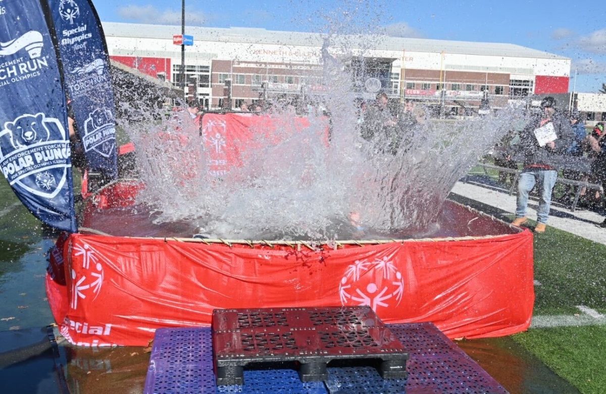 A red tub of water sits with water splashing out as students plunge into the tub. On Saturday, NIU and the Special Olympics Illinois put on the first huskie Polar Plunge. (Courtesy of Special Olympics Illinois)