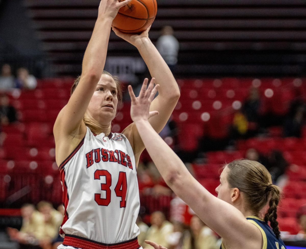 Senior forward Brooke Stonebraker (34) shoots a jump shot over an Akron University opponent. Stonebraker earned her eighth double-double of the season with 15 points and 13 rebounds in Wednesdays win over the University at Buffalo Bulls. (Northern Star File Photo)