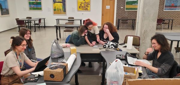 A group of students crowd around a table and make different types of art. NIU’s Makers Club offers a place for NIU students to use their creativity to develop different art projects as group and individually. (Courtesy of Chris English)