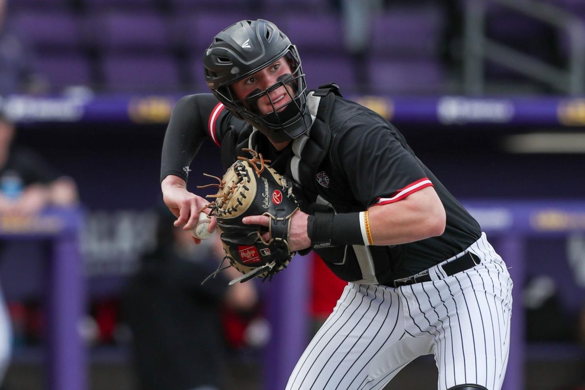 NIU senior outfielder/catcher Colin Summerhill throws during Thursday’s 10-2 loss to then-second-ranked Louisiana State University at Alex Box Stadium in Baton Rouge, Louisiana. Summerhill’s RBI double in the ninth inning of Saturday’s rematch helped the Huskies avoid a shutout in their 5-2 defeat to the third-ranked Tigers. (Courtesy of Jonathan Mailhes)