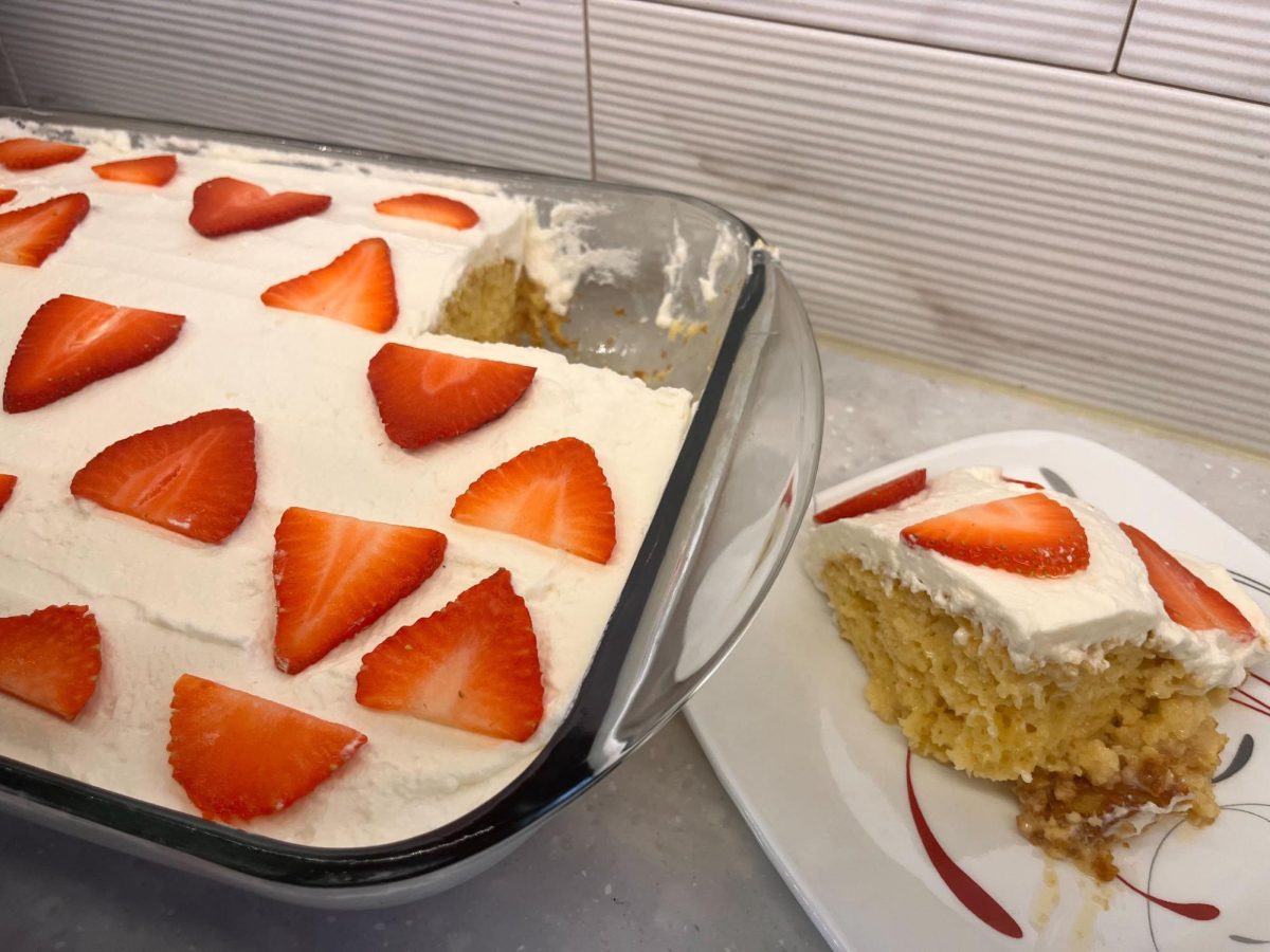 Tres Leches cake covered in strawberries sits in a glass pan. Lifestyle Writer Lindsay Curtis suggests  college friendly recipes for tres leches cake and flan. (Lindsay Curtis | Lifestyle Writer