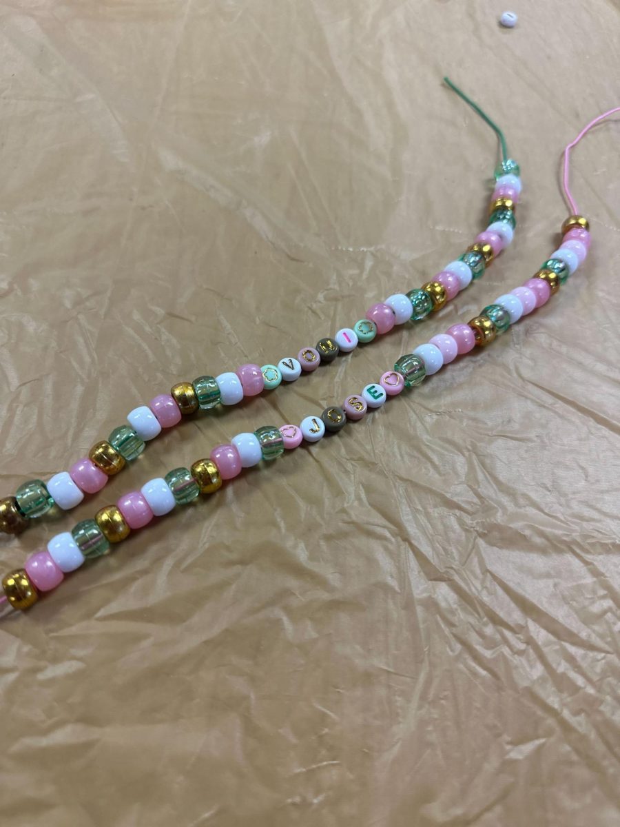 Two multicolored bracelets sit side by side on a table. On Tuesday, the Latino Resource Center hosted a Valentines arts and crafts event for students. (Isabel Cambray | Northern Star)
