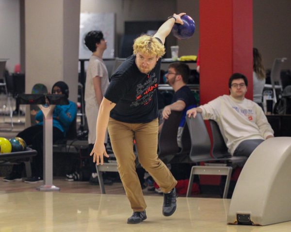 Jacob Bibik, a sophomore business major, lifts his arm back to deliver the ball down the lane. Bibik is the vice president of the Huskie Student Bowling League. (Tim Dodge | Northern Star)