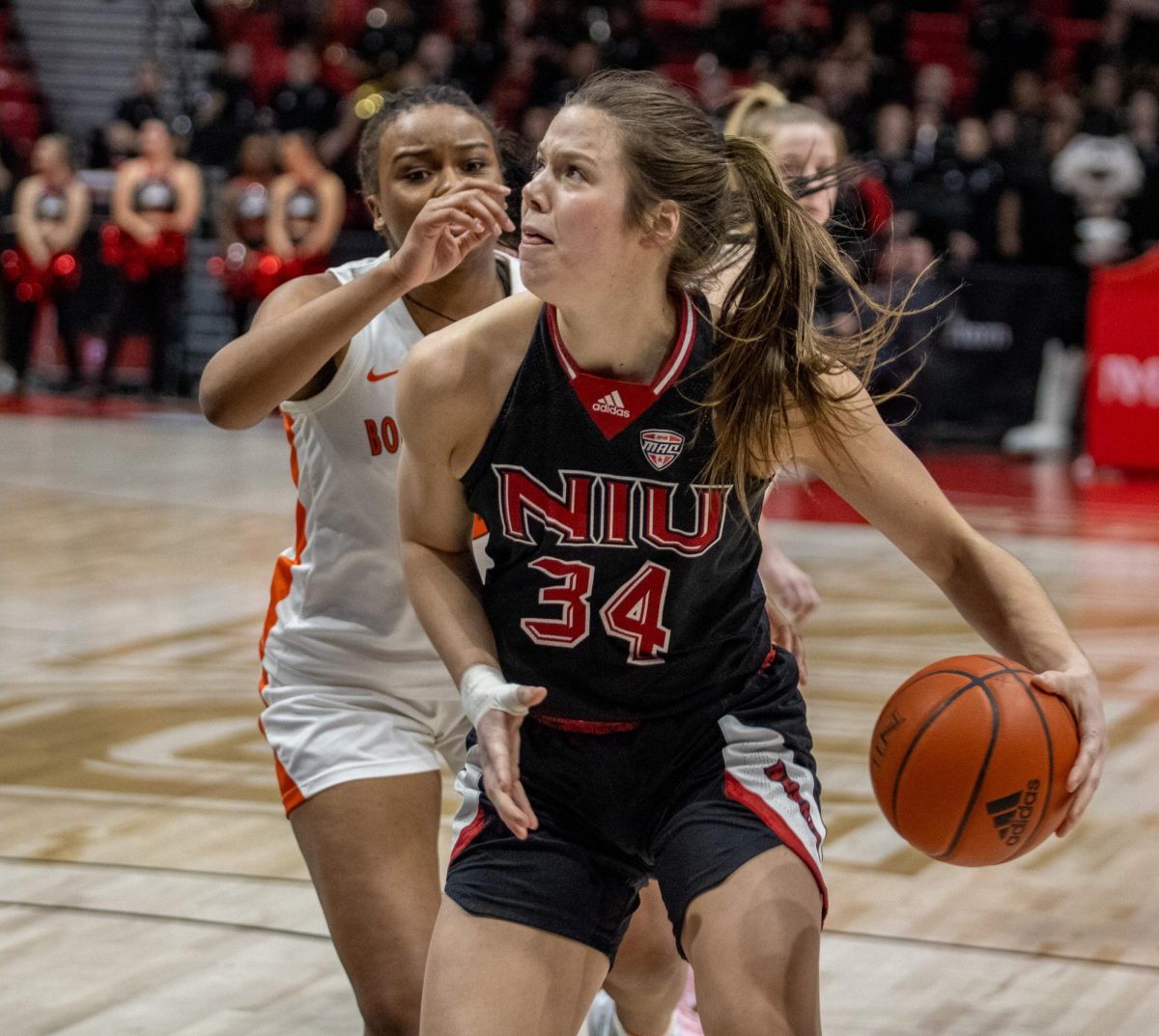 Senior forward Brooke Stonebraker (34) looks to put up a shot past Bowling Green defenders. Stonebraker had 13 points and nine rebounds as the Huskies lost to Bowling Green Saturday 82-73. (Tim Dodge | Northern Star)
