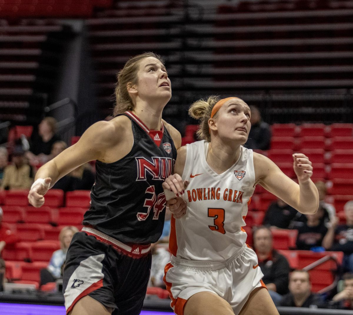 Senior forward Brooke Stonebraker (34) attempts to box out Bowling Green State University senior forward Sophie Dziekan (3). Stonebraker scored 13 points in a 82-73 loss to the Falcons Saturday. (Tim Dodge | Northern Star)