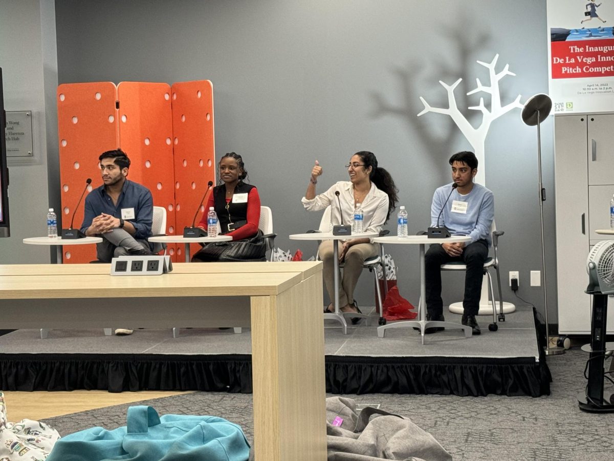 Gustavo Casas (from left), Gabrielle Foreman, Tayyaba Ali and Shazor Kahn sit at a table while Ali gives a thumbs up to a person in the audience. The Young Trailblazers Panel brought four Generation Z CEO’s and entrepreneurs to talk to NIU students about their paths to success. (Gabby Crabtree | Northern Star)