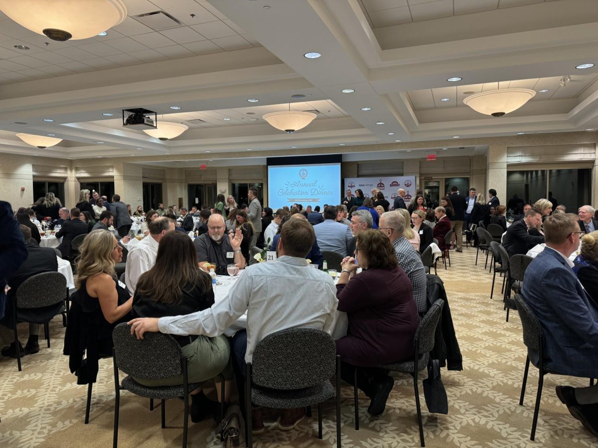 People are sitting at a table and talking. DeKalb Chamber of Commerce held the 100th Annual Celebration Dinner Thursday at the Barsema Alumni and Visitors Center. (Gabby Crabtree | Northern Star) 
