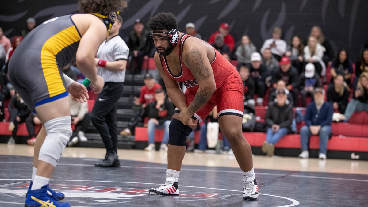 Redshirt sophomore Jacobi Jackson studies his opponent in an NIU wrestling home meet against Kent State University on Dec. 19, 2023. Jackson was named the MAC Co-Wrestler of the Week Tuesday. (Courtesy of NIU Athletics)