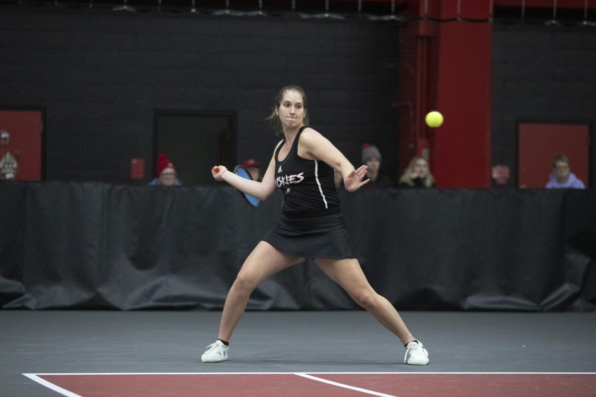 Junior Reagan Welch prepares for a strike at the Nelson Tennis Center at Chick Evans Field House. Welch won her singles match against Valparaiso University sophomore Elizabeth Sobieski Saturday, as well as her doubles match with senior Anastasia Rakita. (Courtesy of NIU Athletics)