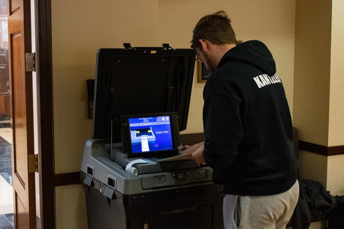 NIU student Liam Kantzler inserts his ballot into the tabulation machine on Nov. 7, 2022 after going through the voting process on Election Day at the Barsema Alumni & Visitors Center on campus. The U.S. Department of Education released a Toolkit for the Promotion of Voter Participation for Students on Monday. (Sean Reed | Northern Star)
