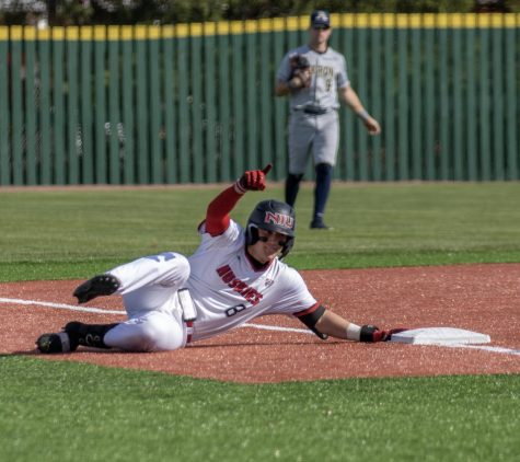 Then NIU junior catcher Colin Summerhill (8) slides into third base after hitting a triple on April 28, 2023 against University of Akron. Summerhill had 2 hits, 2 runs and 3 RBIs in a 14-4 win over Northwestern State University Friday. (Northern Star File Photo)