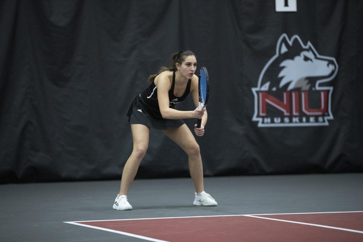 Junior Erika Dimitriev awaits a serve in a match against University of Wisconsin-Madison on Jan. 20. Dimitriev won in both singles and doubles in NIUs win over Bellarmine University on Saturday. (Courtesy of NIU Athletics)