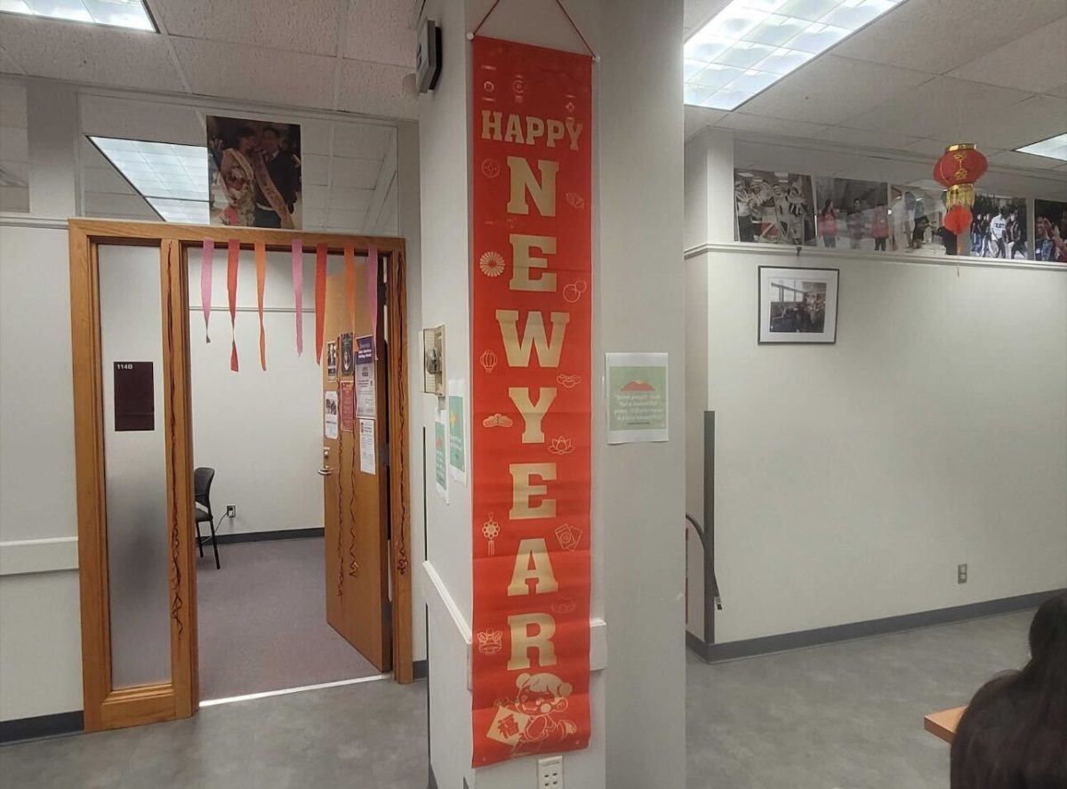 A banner reading “HAPPY NEW YEAR” hangs on a column in the Asian American Resource Center. The 2024 Lunar New Year is Saturday and NIU’s Asian American Resource Center is celebrating this week. (Kayla Martin | Northern Star) 