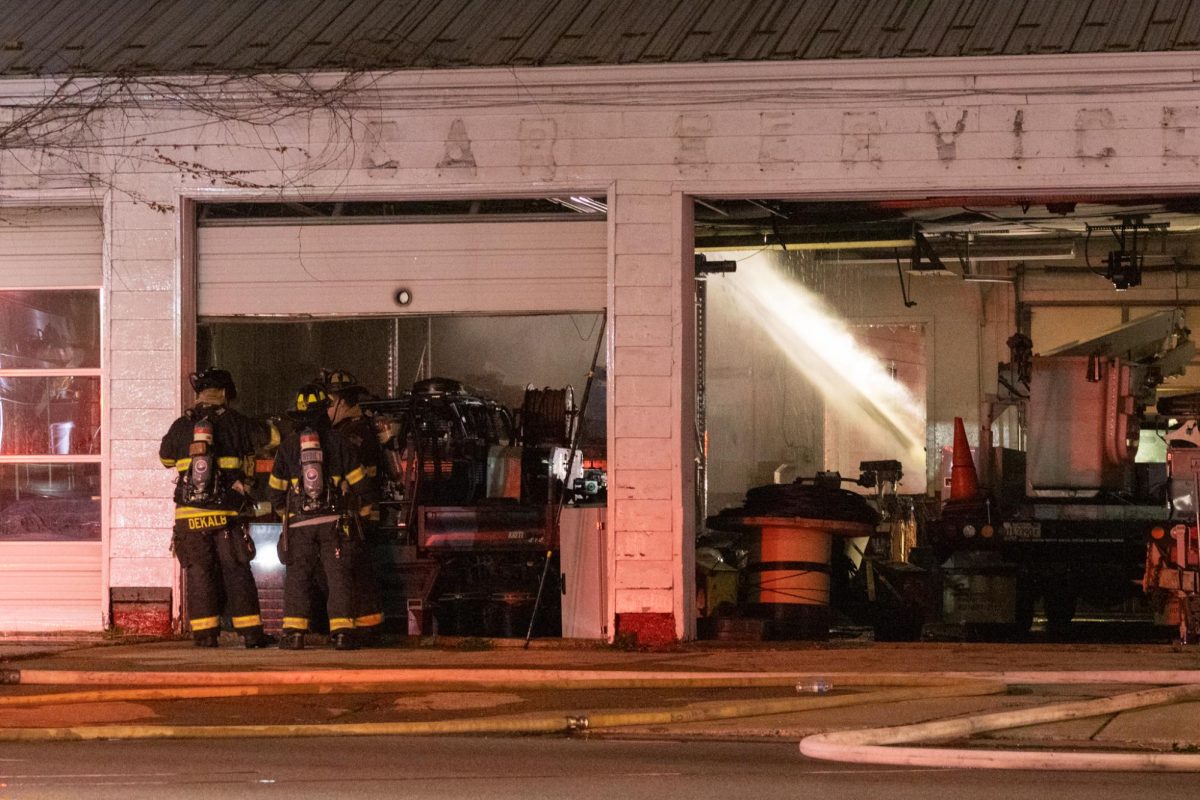 Water+shoots+into+the+old+Illini+Tire+Co.+building+as+firefighters+look+at+the+damage.+At+11%3A02+p.m.+on+Tuesday%2C+firefighters+and+emergency+crews+arrived+to+a+structure+fire+at+1031+W.+Lincoln+Highway+.+%28Sean+Reed+%7C+Northerner+Star%29