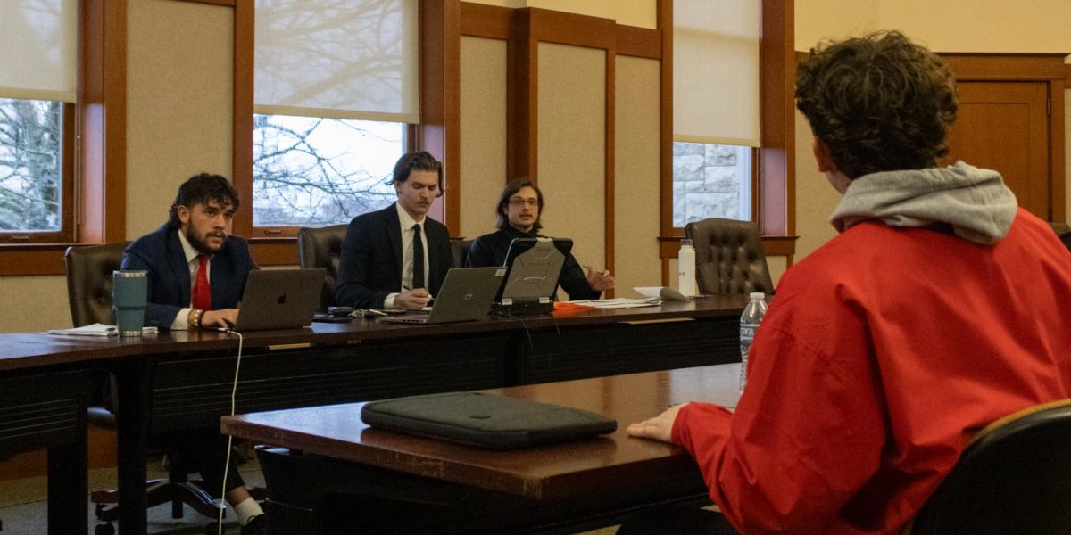 Student Government Association Supreme Court Justices Tyler Murray (from left), Elliot Weiskopf and Maximilian Jarmula listen to complainant Ethan Pesaventos remarks Monday. The Court heard Pesaventos complaint of being excluded from the ballot, to which the court ruled in his favor. (Sean Reed | Northern Star)