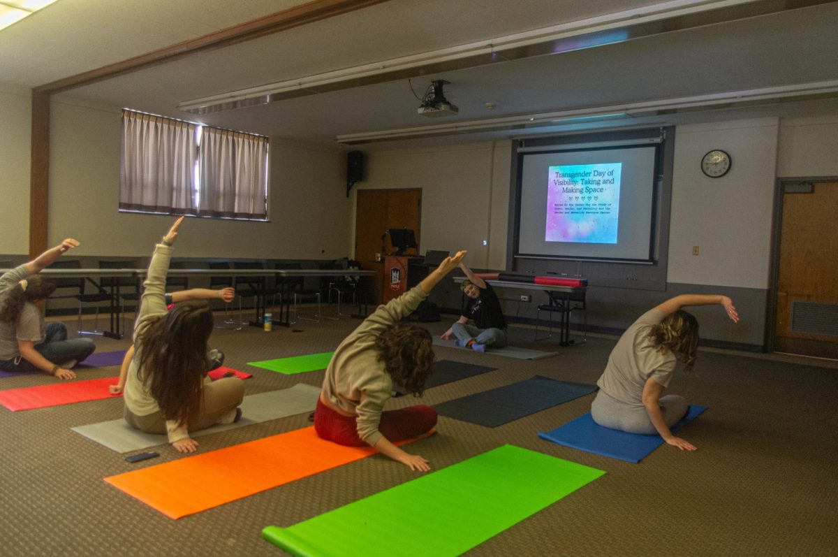 A group of students does stretches to de-stress and relax after yoga during the Transgender Day of Visibility “taking and making space” event. Along with Transgender Day of Visibility, the Transgender Day of Remembrance is held each year on Nov. 20 to bring awareness to deaths of transgender people due to anti-trans violence. (Sam Dion | Northern Star)