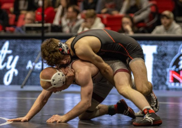 NIU redshirt sophomore Blake West grapples on the back of Lock Haven freshman Logan Sallot on Feb. 9. West was eliminated in the first round at the 2024 NCAA Championships. (Northern Star File Photo)