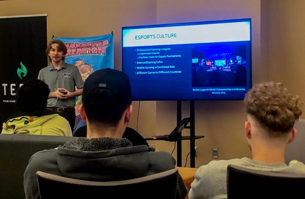 Jakob Furgat speaks to the group about the Esports culture in Asia on Tuesday night in the Esports Arena at Altgeld Hall. The event was hosted by the Asian American Resource Center Ohana Series in collaboration with NIU Esports. (Tim Dodge | Northern Star)