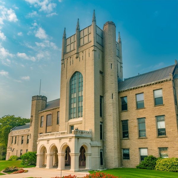 An AI interpretation of Northern Illinois University’s Altgeld Hall stands under a blue sky, developed by the AI image generator site Adobe Firefly. The Northern Star will be run by AI effective immediately, covering campus and local news via artificial intelligence. (Adobe Firefly Image)