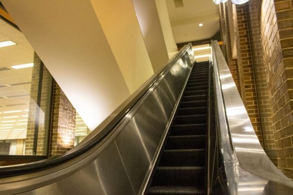 An escalator sits still in Founders Memorial Library. The escalators have been shut down for the last six months due to an underground power failure and possible mechanical issues. (Sean Reed | Northern Star)