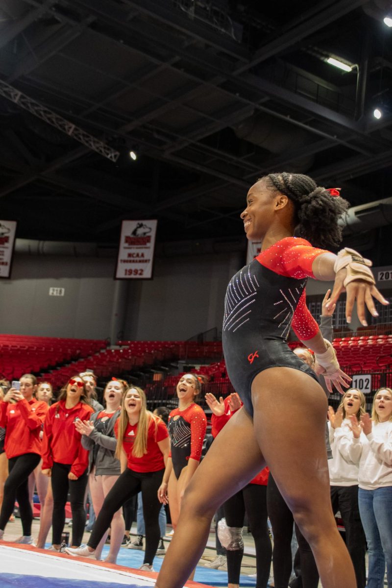 Freshman gymnast Isabella Ross ends her routine with the Huskie hand sign. Ross ended her floor routine with a score of 9.750. (Katie Follmer | Northern Star)