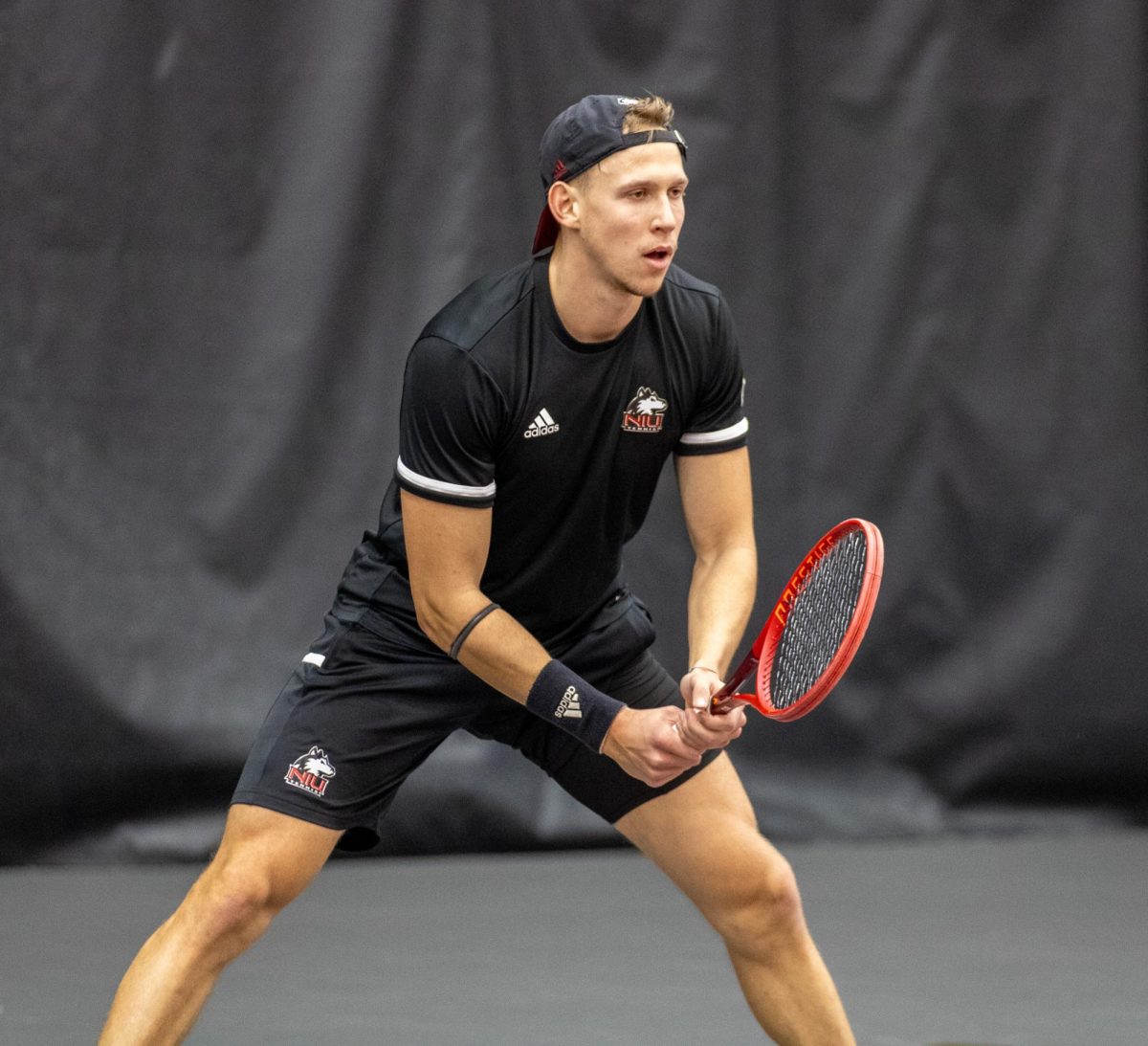 NIU senior Mikael Vollbach gets set to receive the serve during singles. Vollbach scored the Huskies’ second point in a tight match that went to a second set tiebreaker as he defeated University of Nebraska Omaha sophomore Ryoma Mishiro with scores of 6-4, 7-6 and 7-5. (Tim Dodge | Northern Star)