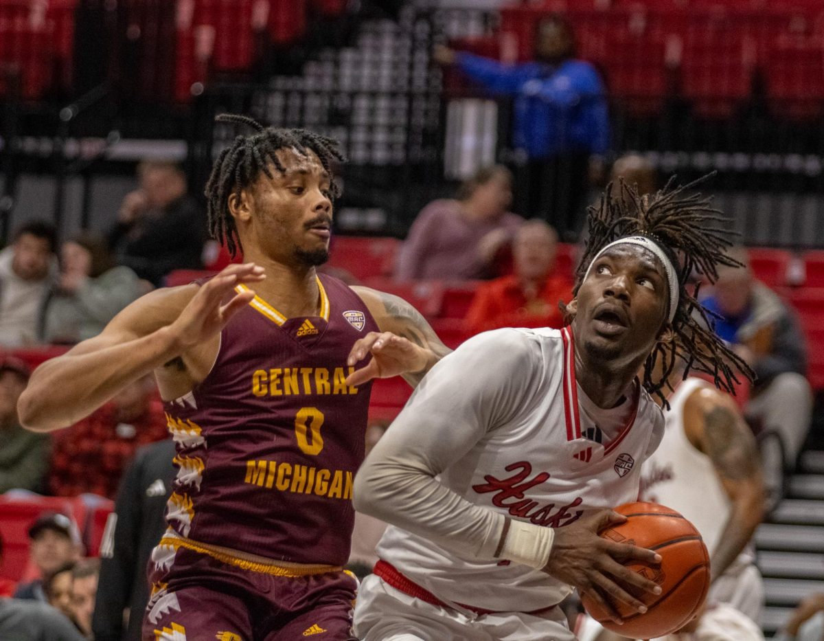NIU+freshman+guard+Will+Lovings-Watts+%281%29+looks+to+put+up+a+shot+under+the+basket+against+Central+Michigan+graduate+student+guard+Brian+Taylor+%280%29.+The+two+teams+shot+nearly+identical+percentages+from+the+field%2C+NIU+at+39.7%25+and+Central+Michigan+at+40.7%25.+%28Tim+Dodge+%7C+Northern+Star%29