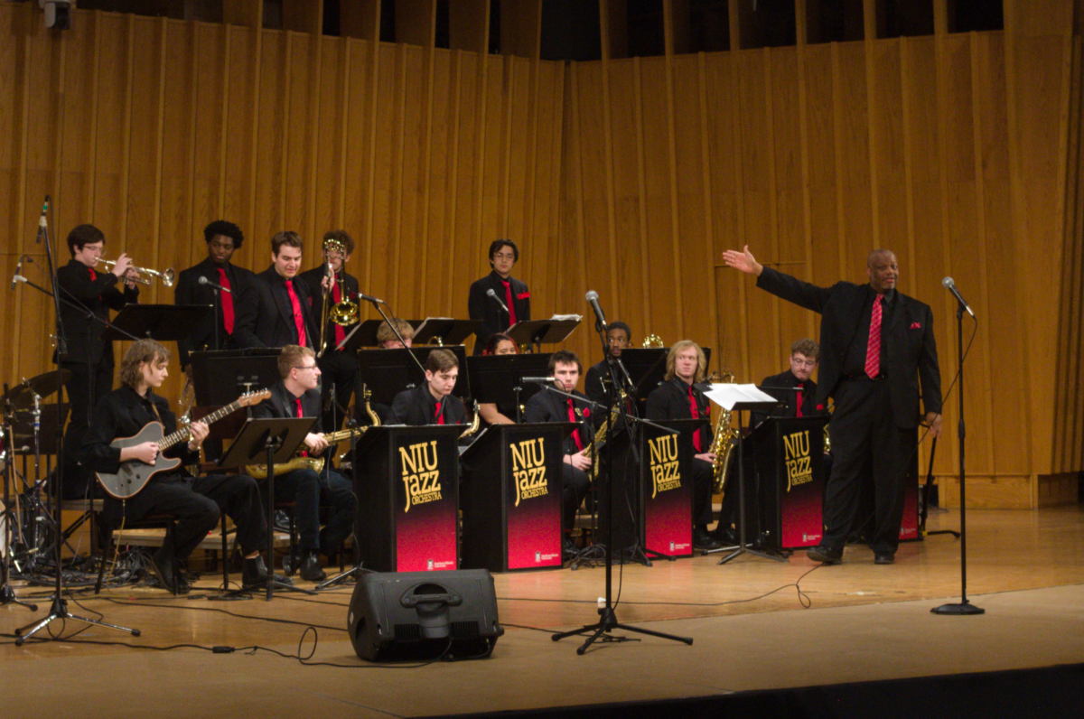 Reginald+Thomas%2C+the+director+of+the+NIU+Jazz+Orchestra%2C+highlights+the+orchestra+by+extending+his+arm+toward+it.+The+orchestra+played+a+concert+Wednesday+with+the+NIU+Jazz+Ensemble.+%28Sam+Dion+%7C+Northern+Star%29
