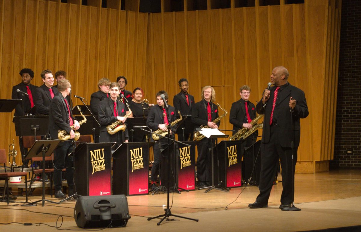 NIU+Jazz+Orchestra+director+Reginald+Thomas+speaks+about+how+Ronald+Carter+would+end+performances+and+demonstrates+the+call+and+response+used+by+Carter+with+the+audience.+The+NIU+Jazz+Orchestra+and+Jazz+Ensemble+worked+to+memorialize+Ronald+Carter+and+his+impact+throughout+the+concert.+%28Sam+Dion+%7C+Northern+Star%29