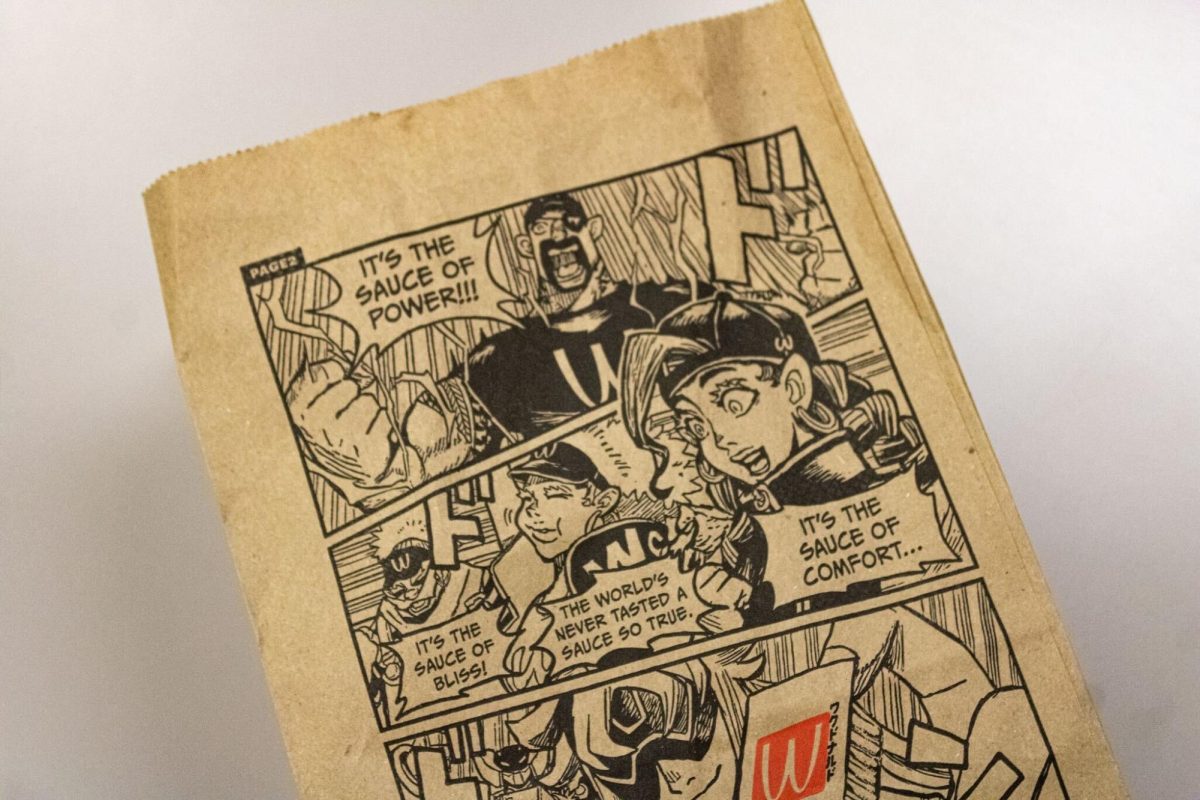 A McDonalds bag decorated with anime rests on a white surface. Weekly manga is a recently added tie-in McDonalds has with their new Savory Chili WcDonalds sauce. (Sean Reed | Northern Star)