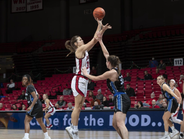 Senior forward Brooke Stonebraker shoots a jump hook over an Eastern Illinois University opponent on Dec. 18, 2023. In her first year as a starter, Stonebraker finished the 2023-24 season as the Huskies leader in points and rebounds. (Northern Star File Photo)