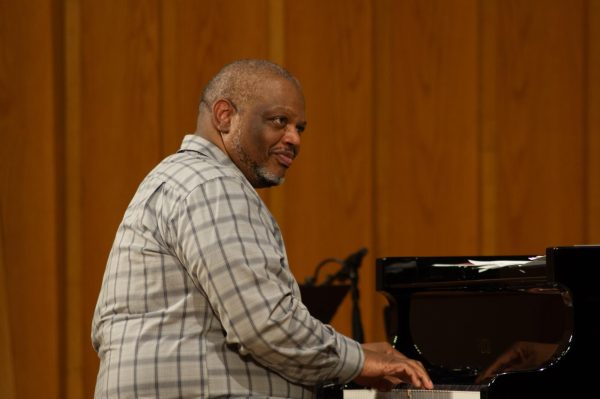 Reggie Thomas, the coordinator of the NIU jazz studies program, plays the piano during his piece “Three Kids.” Three Kids” is a piece Thomas wrote about his kids and the dynamics of having three. (Sam Dion | Northern Star) 
