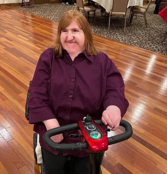 Melissa Blake, a journalist, author and NIU alum, smiles as she sits in her mobility scooter. Blake will be presenting her new book, Beautiful People: My Thirteen Truths About Disabilities, from 1 p.m. to 2 p.m. Thursday in the Founders Memorial Library.