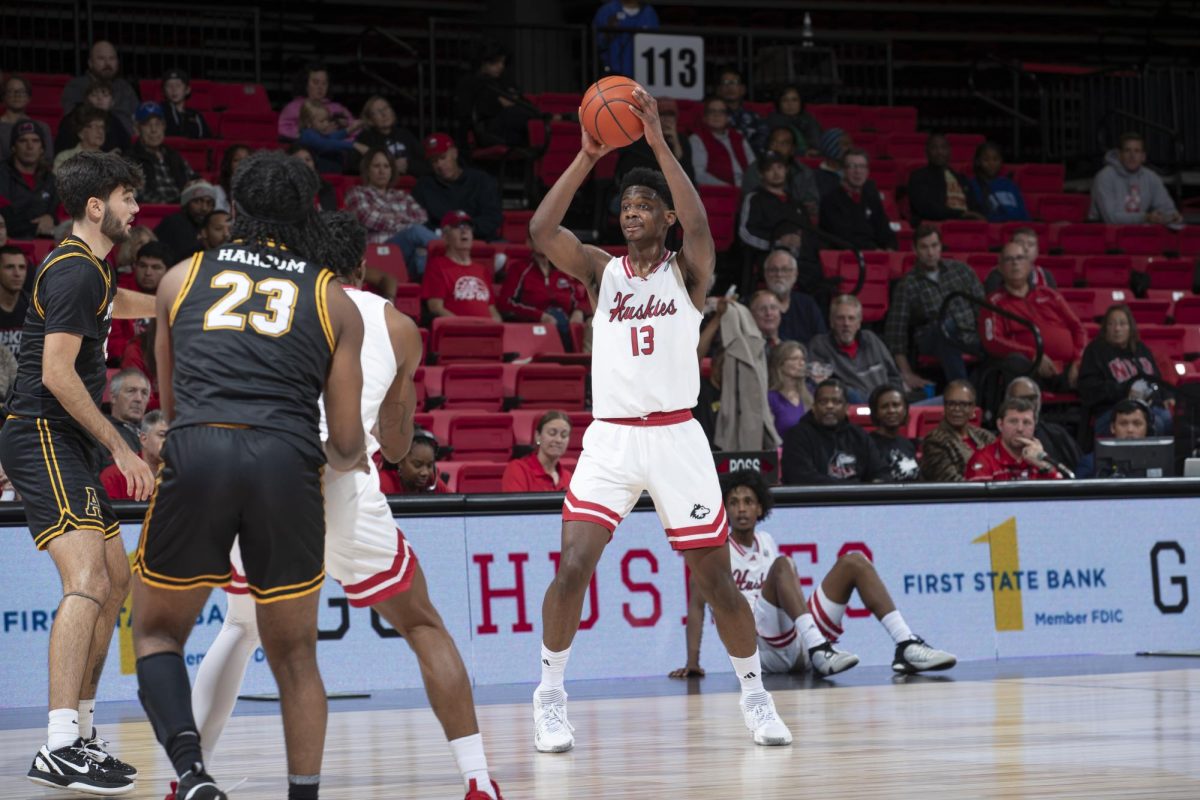 Sophomore forward Xavier Amos looks for an open teammate in an NIU mens basketball home game against Appalachian State University on Nov. 11. Amos announced his commitment to the University of Wisconsin-Madison via Instagram on Monday. (Courtesy of NIU Athletics)