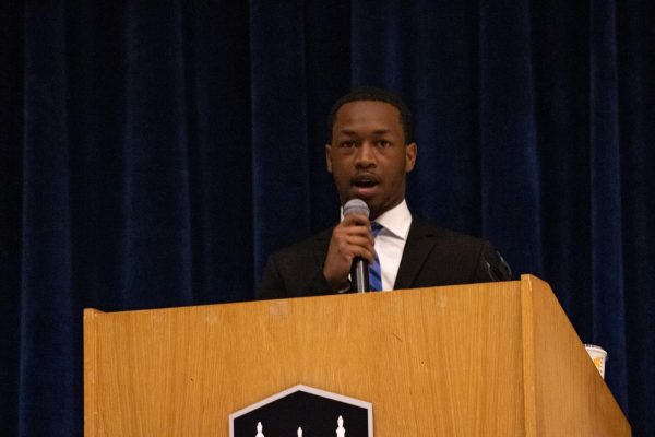 Ja’kobe Jones, SGA presidential candidate, speaks at a podium during the March 22 SGA debates. Jones won the SGA presidential ticket with 1,124 votes. (Sean Reed | Northern Star)