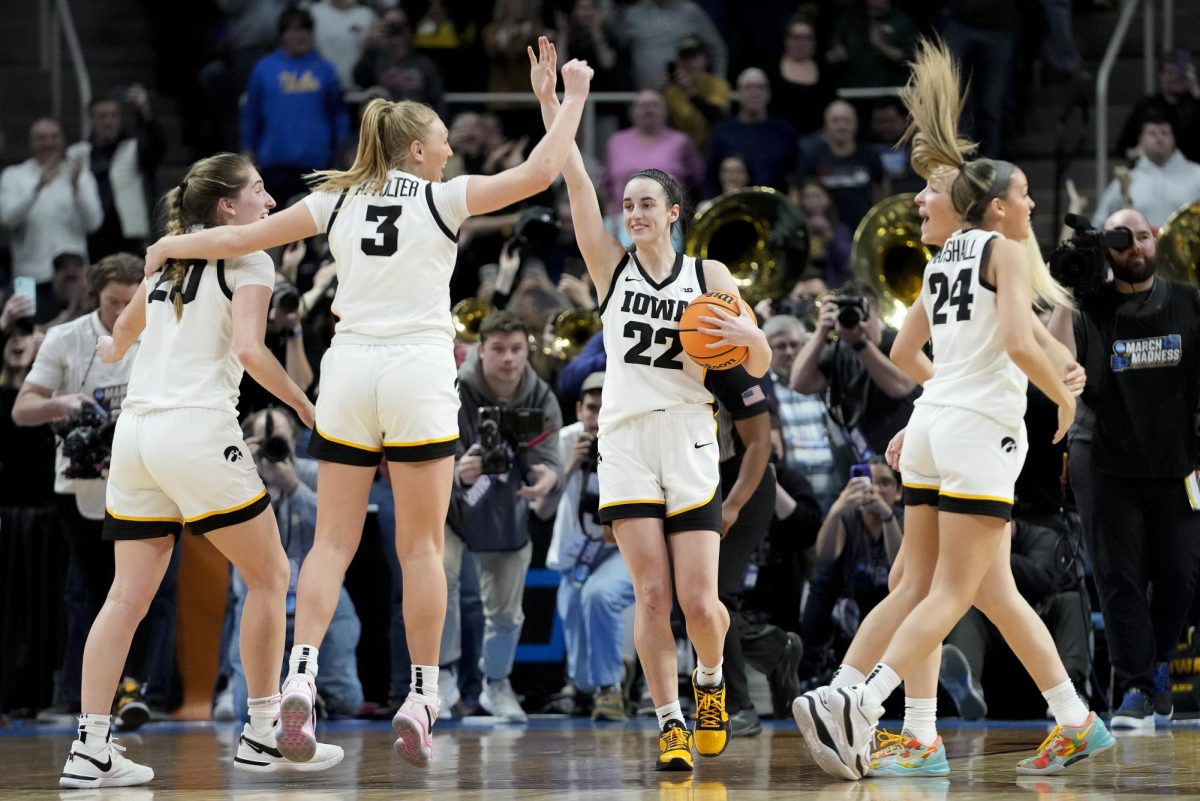 University+of+Iowa+senior+guard+Caitlin+Clark+celebrates+with+her+teammates+after+defeating+Louisiana+State+University+in+the+Elite+8+on+Monday.+Opinion+Columnist+James+Bennett+believes+that+womens+sports+deserve+more+respect+from+the+general+public.+%28AP+Photo%2FMary+Altaffer%29