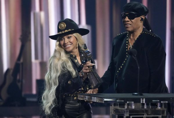 Beyoncé accepts the Innovator Award from Stevie Wonder at the iHeartRadio Music Awards on Monday at the Dolby Theatre in Los Angeles. Beyoncés albums have changed throughout history nad have spanned multiple genres. (AP Photo/Chris Pizzello)