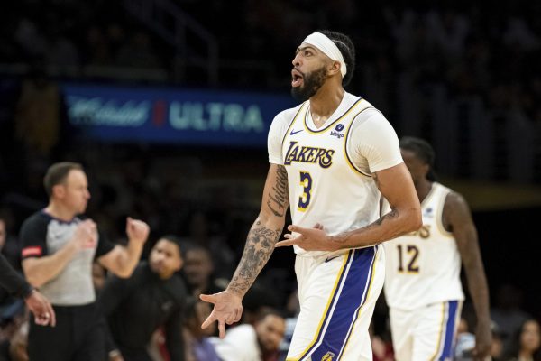 Los Angeles Lakers forward Anthony Davis celebrates a three-point shot in an NBA game against the Cleveland Cavaliers on Saturday. Davis ranks eighth on Sports Reporter Eddie Millers top-10 greatest Chicago-born athletes. (AP Photo/William Liang)
