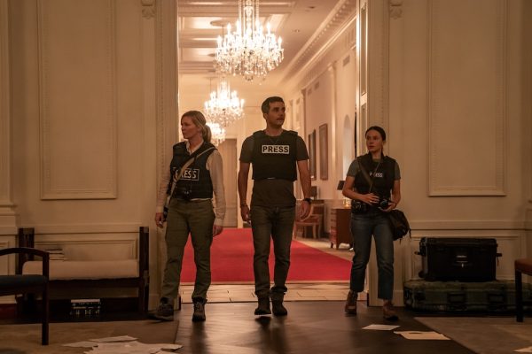 Kirsten Dunst (from left), Wagner Moura and Cailee Spaeny stand inside the White House in a clip from Civil War. Civil War follows a group of journalists looking to interview the president during a civil war. (Murray Close | A24)