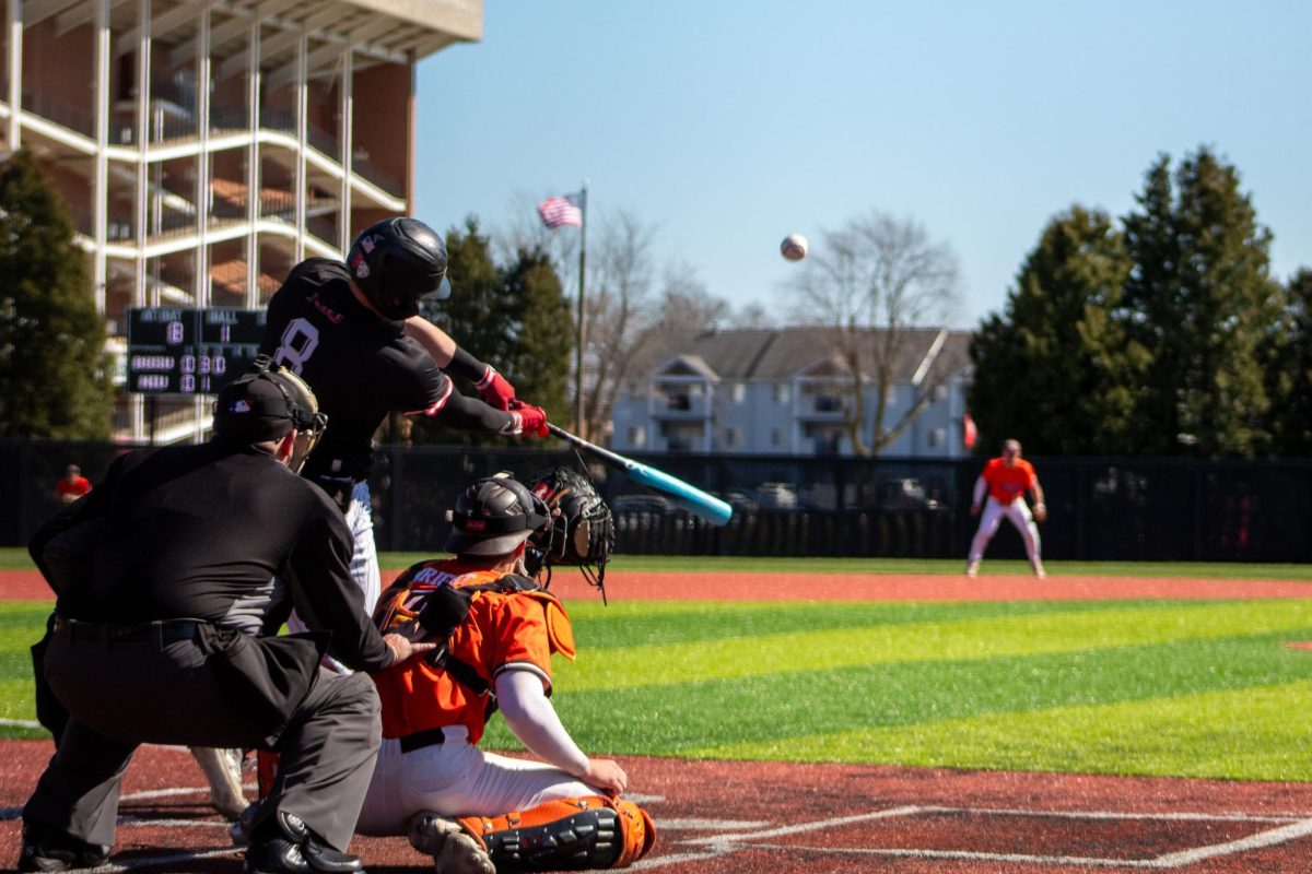 Senior designated hitter Colin Summerhill (8) hits a foul ball to left field during the third inning. Summerhill struck out swinging on the next pitch after his foul, causing the third out of the third inning. (Totus Tuus Keely | Northern Star)