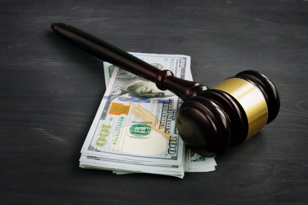 A gavel rests on a stack of money. The Illinois Network for Pretrial Justice will host a media summit on the Pretrial Fairness Act on April 26 in Chicago. (Courtesy of Getty Images)